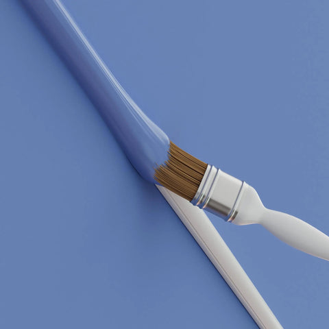 Paintbrush with blue paint on a paintable cover from 157 Inch Cord Cover Kit Easy Peel And Stick Self Adhesive Wire Hiders