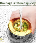 Hand holding Two Pack Stainless Steel Kitchen Sink Strainers With Gold Finish, 4.5 Inch Wide Rim, Mesh Drain Basket Food Catcher