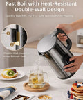 Cordless Electric Kettle With Temperature Control, 1.7L stainless steel kettle pouring hot water into a glass in kitchen