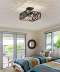 4 Light Modern Black Square Chandelier With Vintage Wood Grain Finish And 180 Degree Adjustable Pole in a bedroom setting