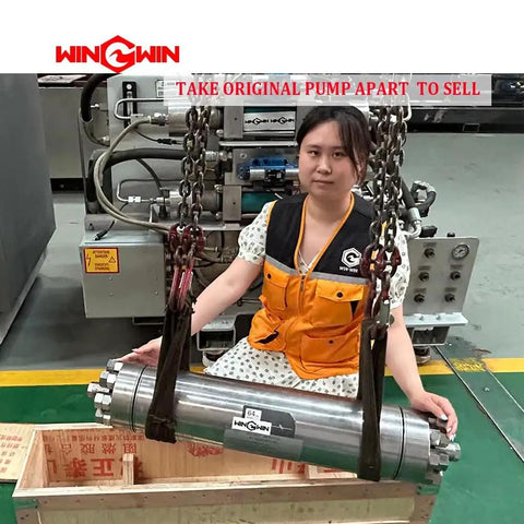 Person with hydraulic pump part in industrial setting