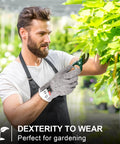 Man wearing cut resistant gloves trimming plants, showcasing Twenty Pairs Cut Resistant Gloves Level 5 Protection For Kitchen Safety And DIY Chopping Slicing Heavy Duty Anti Cut Gloves For Kitchen Use And Garden Projects Comfortable Flexible Fit.