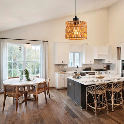 Total Vibe Hand Woven Rattan Pendant Light illuminating a modern kitchen with white cabinets and dining table.