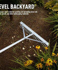 Landscape Rake With Aluminum Head And 68 Inch Handle, 24 Inch Width With 24 Tines in use in a flower bed with mulch and flowers