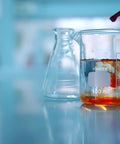 Lab Beaker Set 3.3 Borosilicate Glass Low Form Pack Of 5 50 ML 100 ML 250 ML 500 ML 1000 ML Heat Resistant And Durable For Lab Classroom Home And Industrial Use in use, with liquid being added in a lab setting.