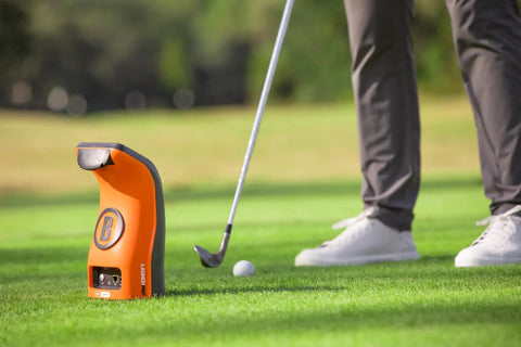 Launch Pro Circle B Edition Launch Monitor With Golf Course GPS Overview on grass with golfer preparing to swing.