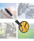 Measuring Wheel 0-9999.9m Digital Display for Construction Worker with yellow wheel and aluminum handle for outdoor measurements.