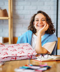 Woman holding 10x13 Inch Poly Mailers 50 Pack Self Seal Shipping Bags with pink bow design, ideal for clothes and small biz