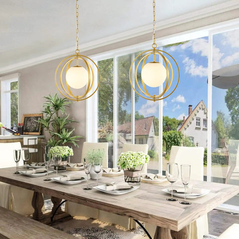 Gold Orb Chandelier 1 Light Globe Pendant Fixture With White Globe Glass Lampshade in a dining room setting