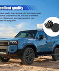 Upgrade Your Whip With These Slick Black Wheel Center Caps Providing Easy Snap Fit Mounting To Keep Rust Off Your Rim Hubs While Keeping Your Daily Driver Looking Tight On The Road. Image shows a blue SUV with black wheel center caps in a desert setting.