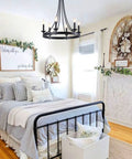 Black Farmhouse Wagon Wheel Chandelier With Six Lights, 24 Inch Rustic Pendant Ceiling Light in cozy bedroom setting