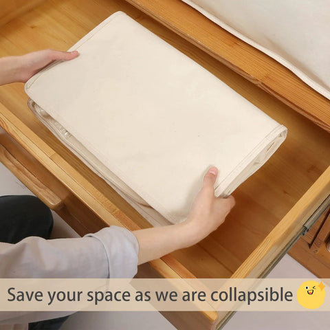Person placing folded Heavy Duty Cotton Storage Bags With Clear Window And Sturdy Zipper 75L in drawer, showcasing storage solution.
