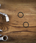 Must Have 10 Piece Rubber Sealing Ring Set For Pail Lids And Oil Buckets, Leakproof And Airtight Gasket Replacement For Farm And Job Site Use, Easy To Install Spare Part, Durable Rubber Seal Keeps Liquids Contained. black rubber sealing rings on wood with wrenches
