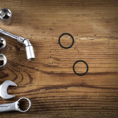Must Have 10 Piece Rubber Sealing Ring Set For Pail Lids And Oil Buckets, Leakproof And Airtight Gasket Replacement For Farm And Job Site Use, Easy To Install Spare Part, Durable Rubber Seal Keeps Liquids Contained. black rubber sealing rings on wood with wrenches
