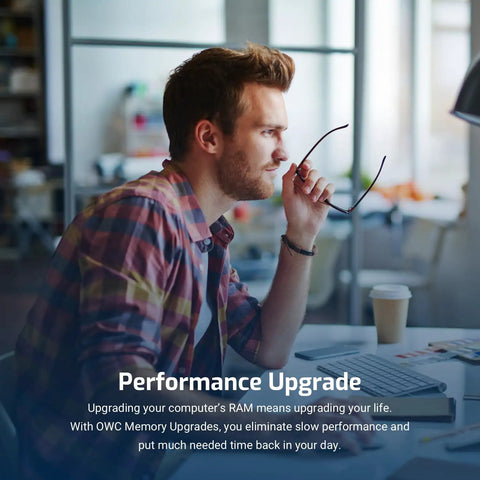 Person sitting at a desk in an office environment with text about performance upgrade and RAM memory upgrade benefits visible.
