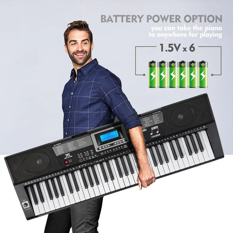Man holding 61 Key Learning Piano Keyboard With Lighted Keys For Beginners, Includes Stand, Pedal, Headphones And Microphone, USB MIDI