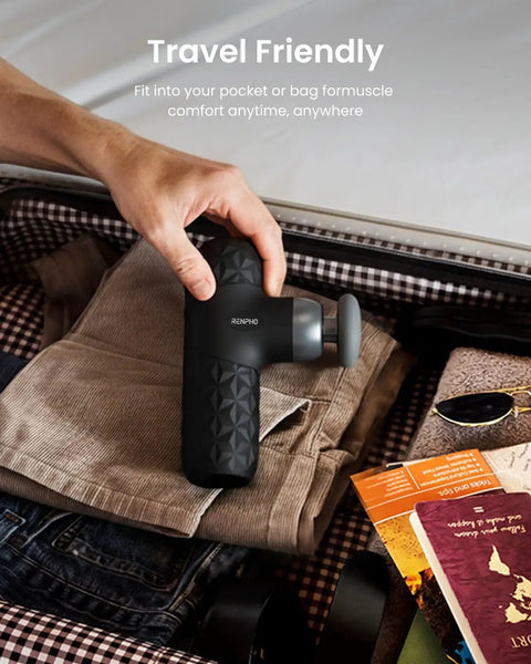Person packing Mini Thermal Massage Gun With Heat Portable Deep Tissue Percussion Massager With Four Heads in suitcase