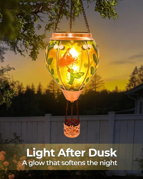 Glass Hot Air Balloon Solar Lantern with Flame Hand Painted Artwork Realistic Flickering Flame Hummingbird Accent at sunset