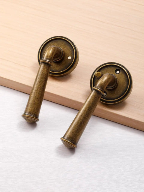 Privacy Door Lever In Antique Brass, Retro Vintage Interior Door Handle For Bedroom And Bathroom, Aluminum Alloy Round Rosette 2.64 Inch, Easy Inside Lock And Emergency Outside Release, 1 Pack shown on wood surface