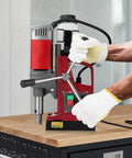 Heavy Duty Magnetic Drill Press With 1450W Motor And Strong 13000N Base being operated with gloves for precise metal boring.