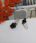 12 Pack Black Zipper Repair Kit Universal Sliders Replacement Zip Pullers For Clothes Bags Luggage And More No Fuss Easy Fix For Broken Zippers Durable And Versatile Sewing Notions on display, showing two black zipper pulls on a white surface.