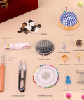 Handheld Sewing Machine With Elegant Wooden Box And 153 Piece Kit accessories including needles, tapes, scissors, and buttons.
