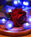 Blue Submersible LED Light Set Tiny But Mighty Battery Powered Flameless Lights With Up To 100 Hours Of Continuous Brightness Waterproof For Wedding Vase Arrangements Party Decor Or Poolside Vibes 24 Pcs around a red rose