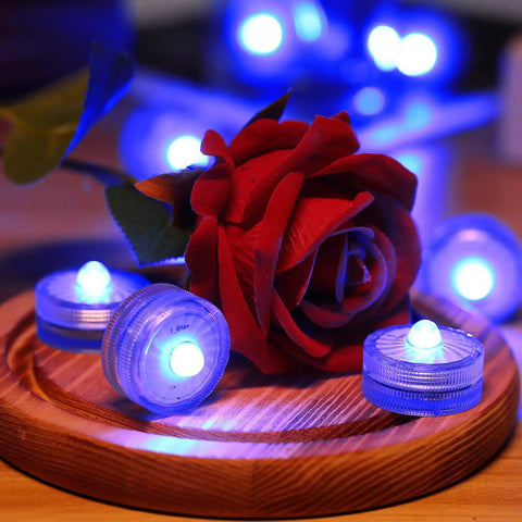 Blue Submersible LED Light Set Tiny But Mighty Battery Powered Flameless Lights With Up To 100 Hours Of Continuous Brightness Waterproof For Wedding Vase Arrangements Party Decor Or Poolside Vibes 24 Pcs around a red rose