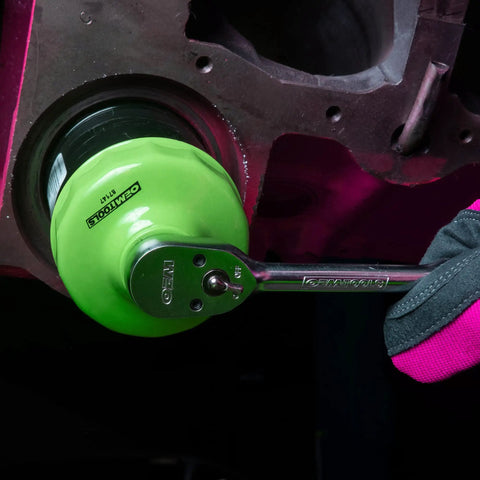 76 Millimeter 14 Flute Oil Filter Wrench for Easy Oil Changes Reinforced Three Eighths Inch Drive in use on engine
