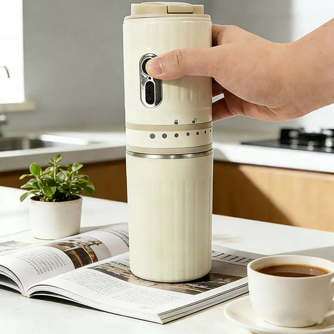 Portable Travel Coffee Maker With Built In Grinder 16 Oz Brew Cup One Touch Manual Drip Brewer held in hand near a potted plant.