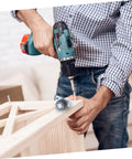 Person using a drill to install Set Of Four Adjustable Door Wheel Rollers For Sliding Closet Barn Doors With Heavy Duty Silent Pulleys.