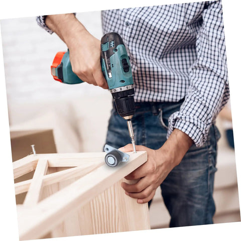 Person using a drill to install Set Of Four Adjustable Door Wheel Rollers For Sliding Closet Barn Doors With Heavy Duty Silent Pulleys.