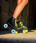 Person skating with black skates featuring Lit Up Roller Skate Wheels 4 Pack Blue LED Quad Wheels For Outdoor Skating