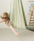 Child enjoying the Ultimate Chill Cotton Sensory Cocoon Swing For Kids Autism And Adhd Therapy Support Indoor Outdoor Hammock.
