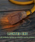 25 Ft Lighted Outdoor Extension Cord With 10 3 SJTW Heavy Duty Yellow Cable And 3 Prong Grounded Plug For Safety UL Listed 15 Amp 125 Volt LED Indicator Lights Up When Powered Durable Copper Wire close-up view with glowing LED