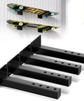 Black floating brackets holding skateboards; Skateboard Wall Mount Shelves 4 Pack Black Floating Brackets For Deck And Longboard Display.
