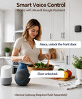 Woman in kitchen using smart speaker to control Slick Matte Black Smart Door Lock Featuring Super Quick Keyless Entry And Tight Bluetooth Handle That Pairs Directly With Your Phone App Control For Hassle Free Access.