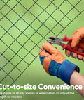Hands cutting 1 Inch Hardware Cloth Roll For Chicken Coops 40 Inch Wide By 50 Feet 20 Gauge Dark Green Vinyl Coated Wire Mesh