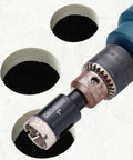 Close-up of blue drill fitted with 1-inch diamond-tipped tile hole saw and pilot bit.