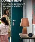 Echo Dot Newest Model With Rich Vibrant Sound Designed For Alexa on table in hallway with child and woman entering room