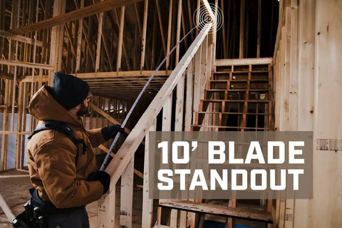 Person using Pro Grade Tape Measure With One And One Eighth Inch Double Sided Blade Military Grade MIL X Coated Case Sixteen Foot Plus Twenty Five Foot Reach High Visibility White Blade With Double Sided Markings True Ten Foot Standout Rugged Non Slip Burr Hook in construction setting