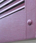 Close-up of Premium Heavy Duty Vinyl Shutter Fastener Spike Lok Anchors on dark gray vinyl shutters affixed to siding.