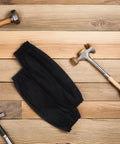 Heavy Duty Waterproof Pu Arm Sleeves 2 Pack Reusable Oilproof Work Guards For Mechanics And Construction, black sleeves on wood surface with tools.