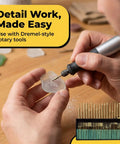 Person using rotary tool from 30 Piece Diamond Rotary Tool Bits Set Pro Grade For Engraving And Carving 120 Grit Burrs One Eighth Inch Shank Dremel Compatible Diamond Burrs For Stone Glass Jewelry Making Etching And Detailing on glass piece.