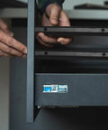 Person installing Black Plastic Drawer Slides With 12 Inch Side Mount Guide Rails And Mounting Hardware for cabinet upgrades.