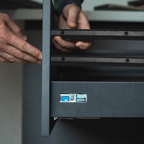 Person installing Black Plastic Drawer Slides With 12 Inch Side Mount Guide Rails And Mounting Hardware for cabinet upgrades.