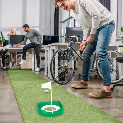 Person practicing putting with Two Pack Golf Putting Cup With Flag For Indoor Outdoor Practice in office.