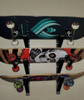 A Badass Skateboard Wall Mount Rack To Keep Your Boards Off The Floor With Adjustable Layers Grabbing Three Decks Securely, holding three skateboards.