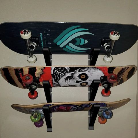 A Badass Skateboard Wall Mount Rack To Keep Your Boards Off The Floor With Adjustable Layers Grabbing Three Decks Securely, holding three skateboards.