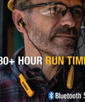 Heavy Duty Bluetooth Neckband Headphones for Jobsite Use with 30 Hour Runtime and Noise Isolation worn by a man at work site
